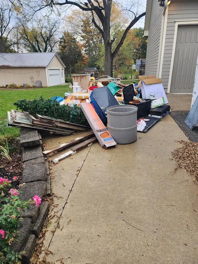 Dumpster being loaded with debris for Roofing Dumpster Rental in Lantana